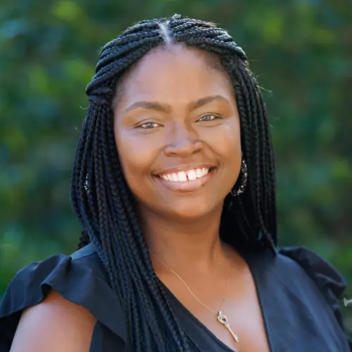 kristen dubose wearing a black shirt smiling into the camera